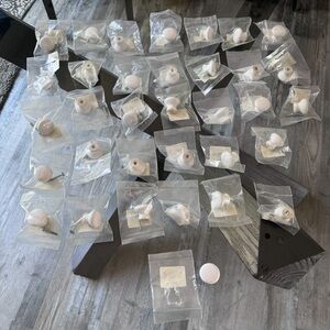 Lot of 34 white cabinet knobs.
